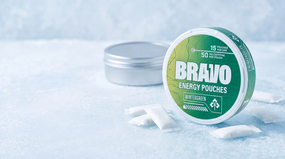 Bravo Wintergreen caffeine pouch can in sharp focus with an unbranded competitor tin softly blurred in the background, editorial hero for ALP Coffee Break review