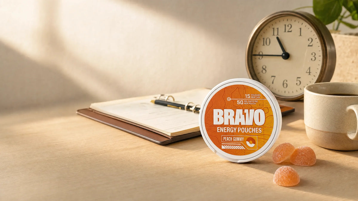 Bravo Peach Gummy caffeine pouch can on a desk beside an analog clock, planner, and peach gummies