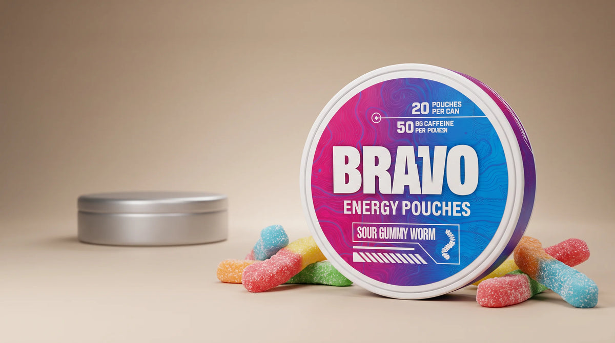 Bravo Sour Gummy Worm caffeine pouch can in sharp focus with sour gummy candies, and one small unbranded competitor tin blurred in the background