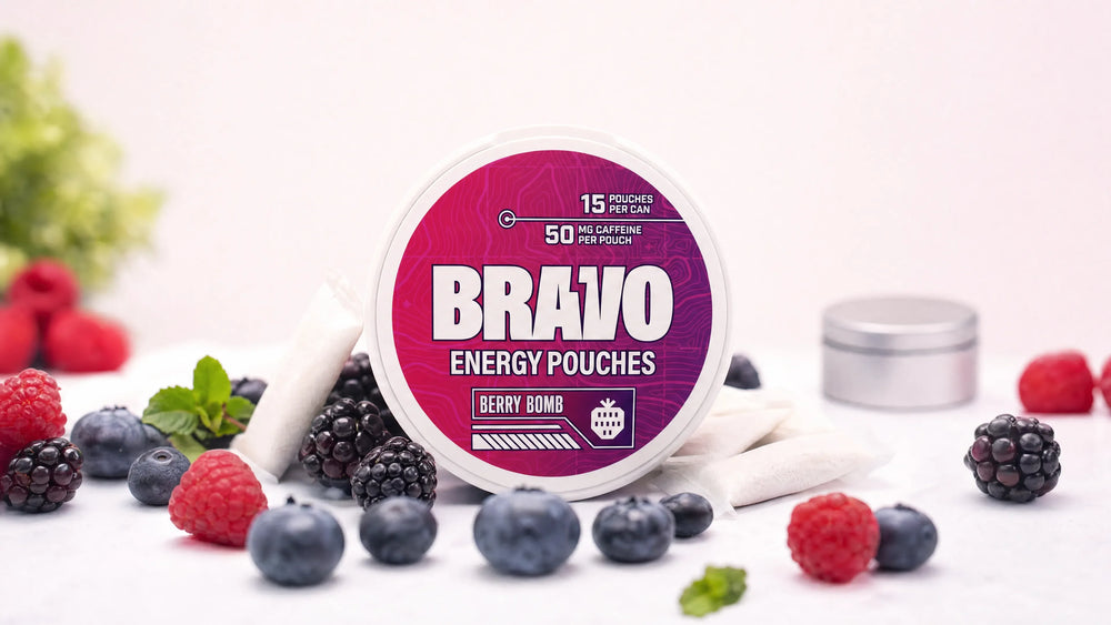 Bravo Berry Bomb caffeine pouch can surrounded by fresh mixed berries, a Deckiez caffeine pouch review hero image