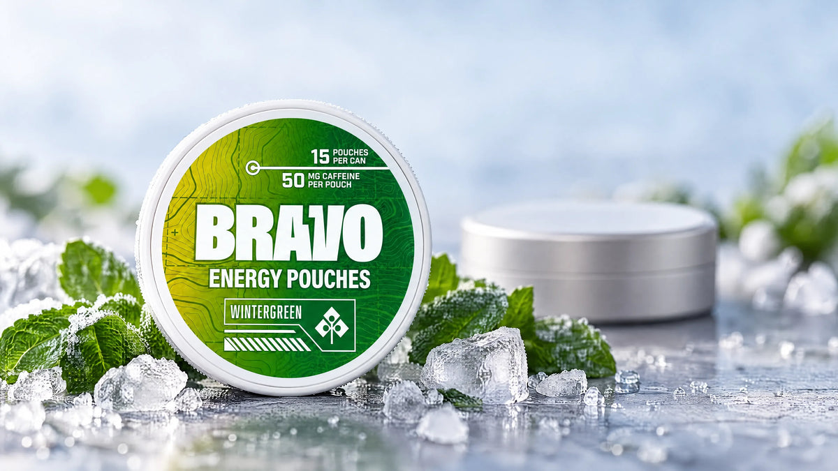 Bravo Wintergreen caffeine pouch can next to a small unbranded competitor tin, editorial hero for the Teaza Energy Pouches review