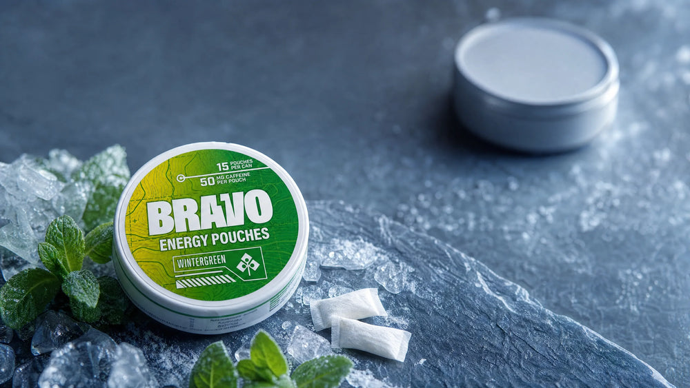 Bravo Wintergreen caffeine pouch can beside a soft-focus competitor tin, editorial hero for the Ultra Energy Pouches Review 2026