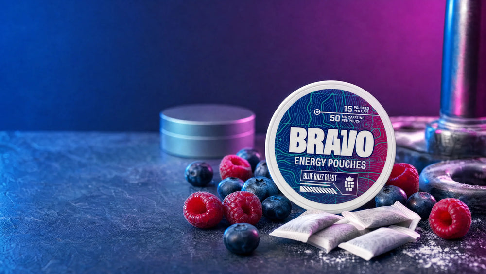 Bravo Blue Razz Blast caffeine pouch can next to blueberries and raspberries, with a generic soft-focus competitor tin in the background