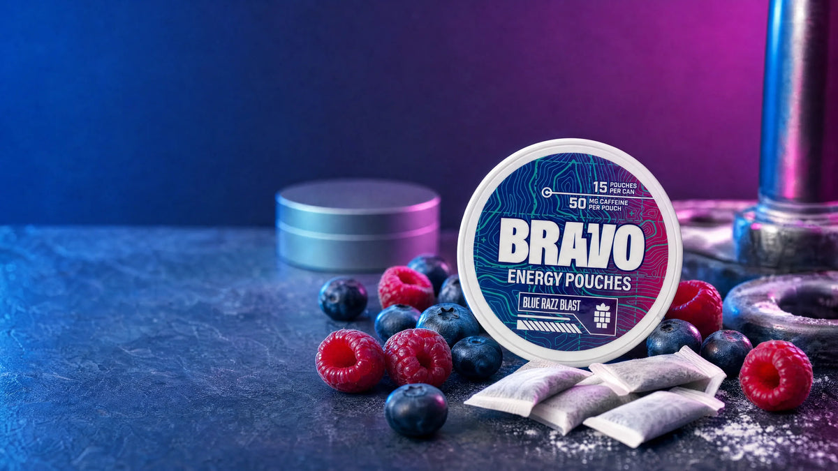 Bravo Blue Razz Blast caffeine pouch can next to blueberries and raspberries, with a generic soft-focus competitor tin in the background
