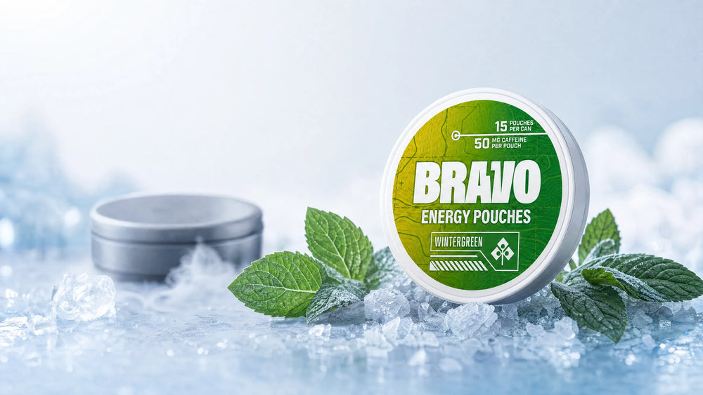 Bravo Wintergreen caffeine pouch can, sharp focus, with a small unbranded competitor tin blurred in the background