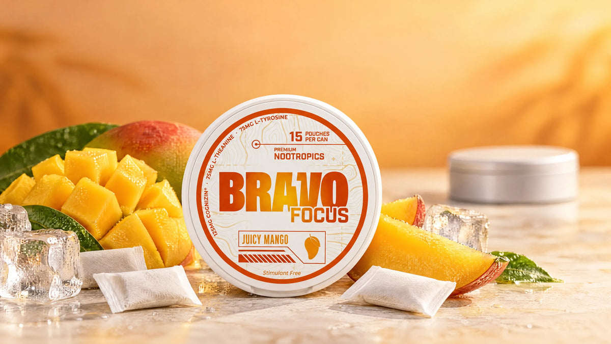 Bravo Focus Juicy Mango pouch tin in a studio hero shot with fresh mango and ice, comparing nootropic focus pouches