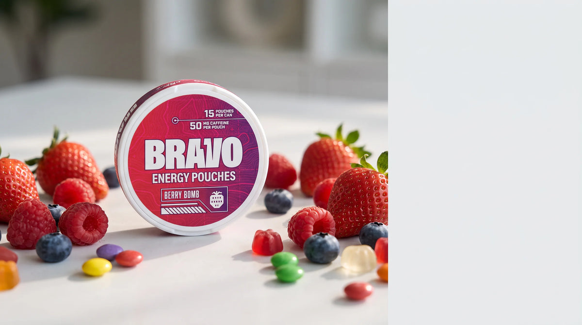 A single Bravo Berry Bomb caffeine pouch tin as the hero subject with berries and candy props on a light editorial studio surface