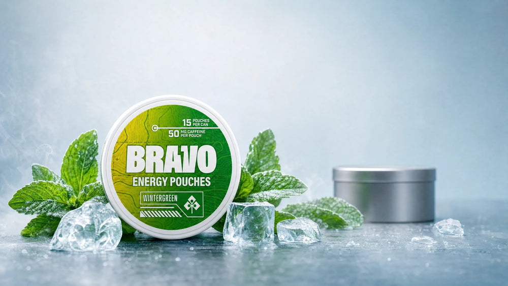 Bravo Wintergreen caffeine pouch can with mint leaves and ice, editorial hero for the BUM Energy Pouches review