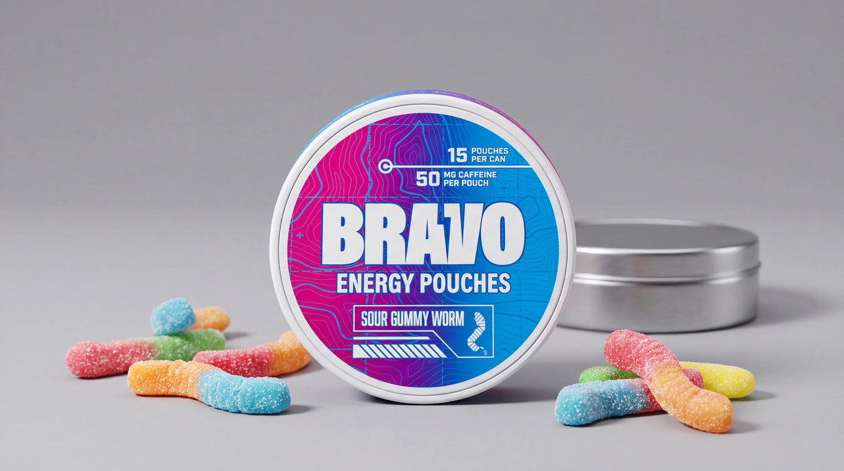 Bravo Sour Gummy Worm caffeine pouch can in sharp focus with a plain unbranded competitor tin in the soft-focus background and loose gummy candy props