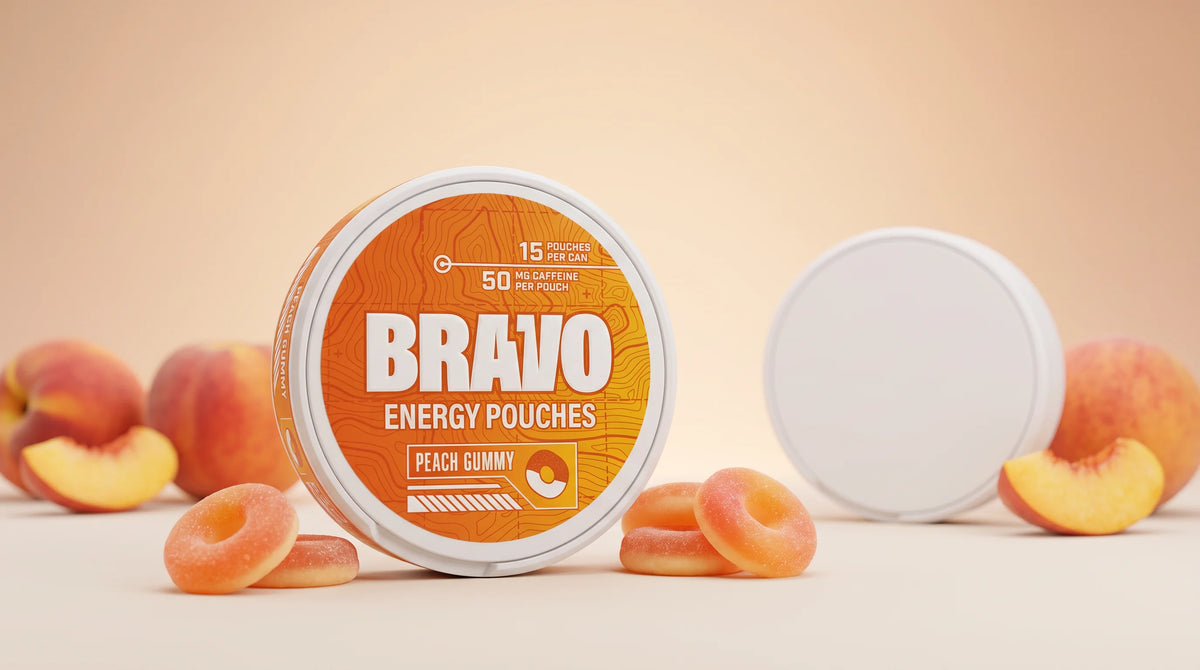 Bravo Peach Gummy caffeine pouch can in sharp focus with peach gummy candies, and a generic unbranded competitor pouch tin blurred in the background — Nectr vs Bravo caffeine pouch review.